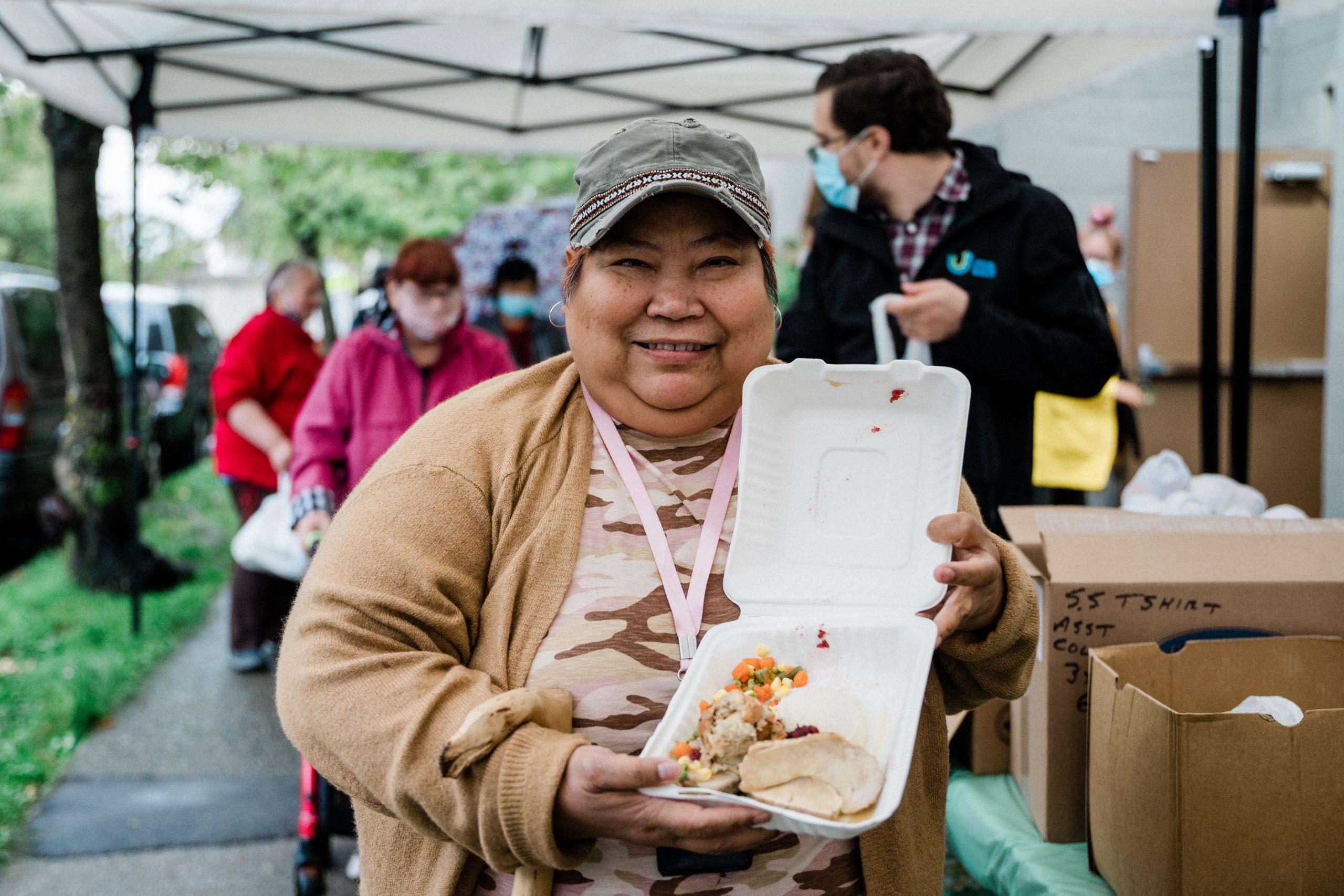 Woman showing food in box