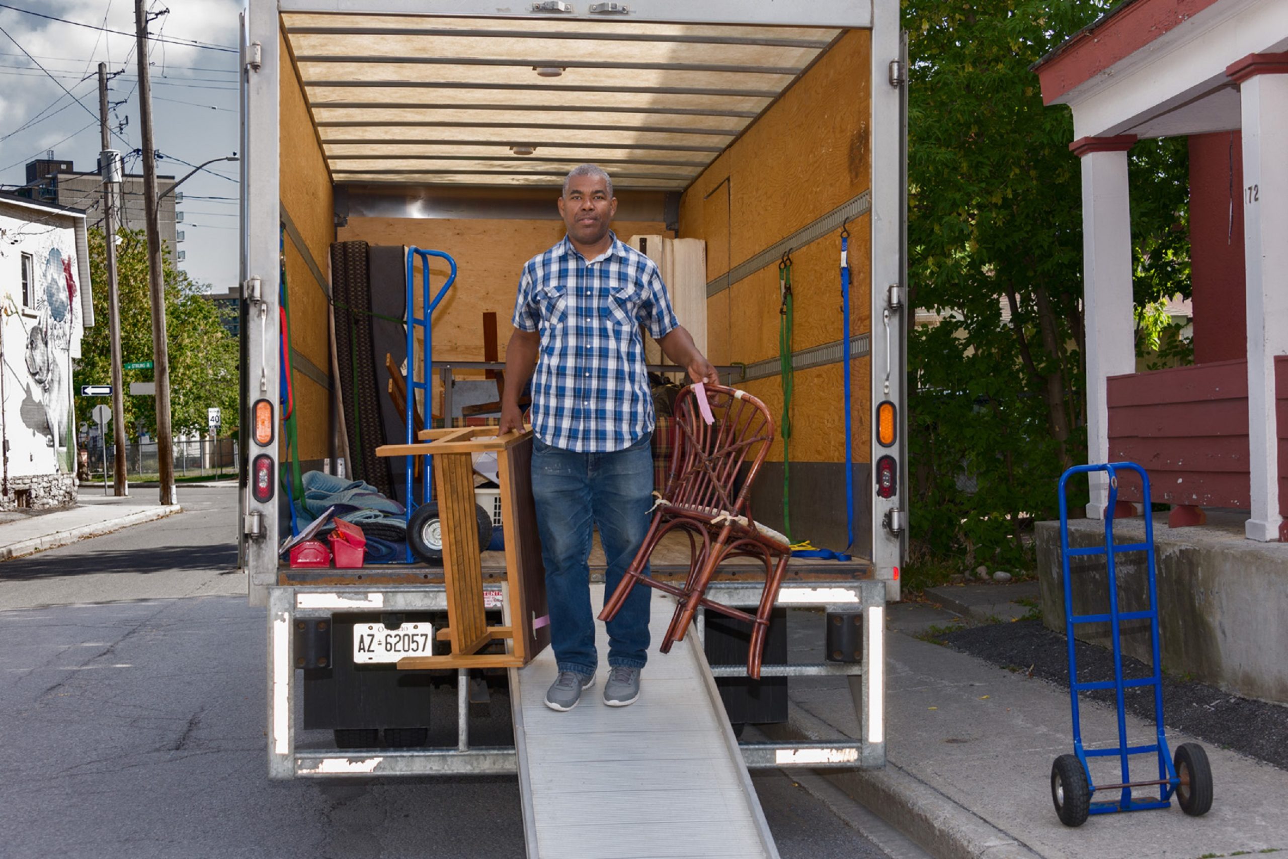 Man taking furniture off truck