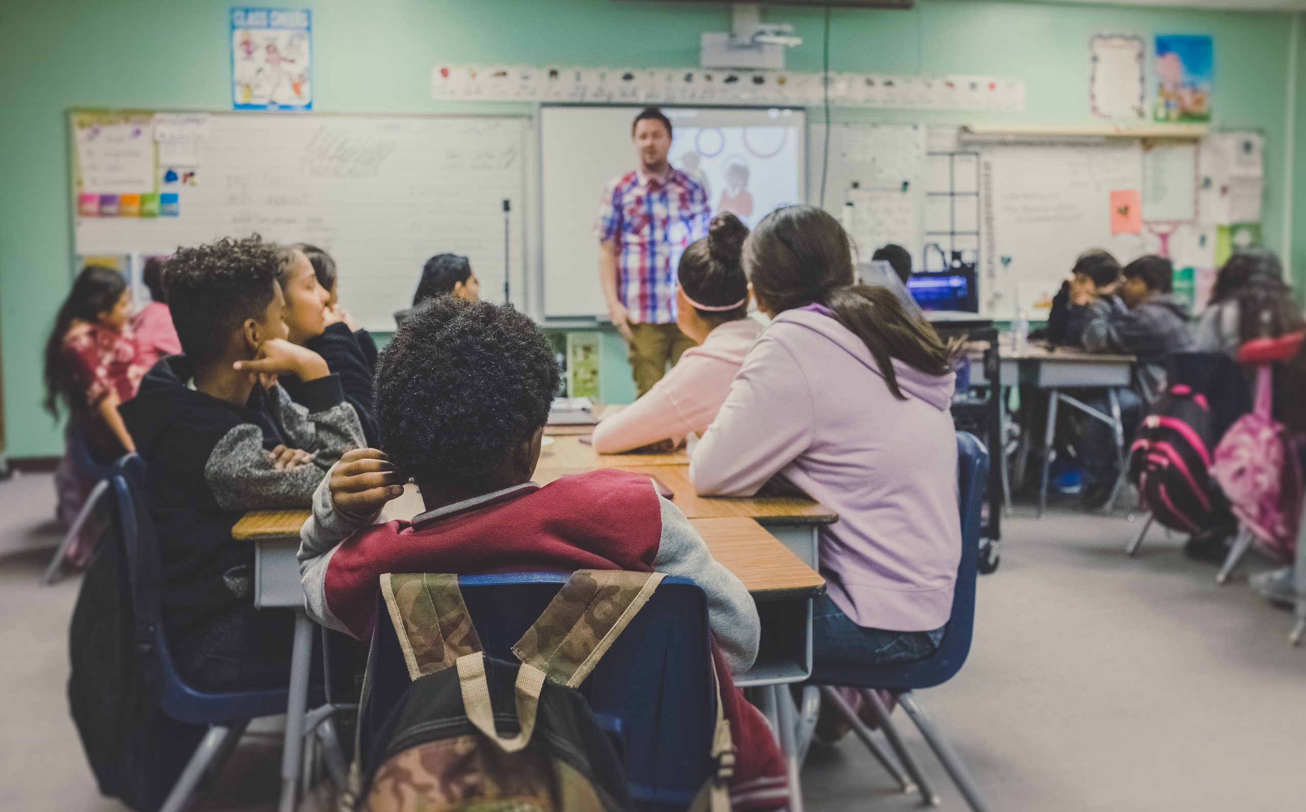 Students listen to their teacher giving a lecture.