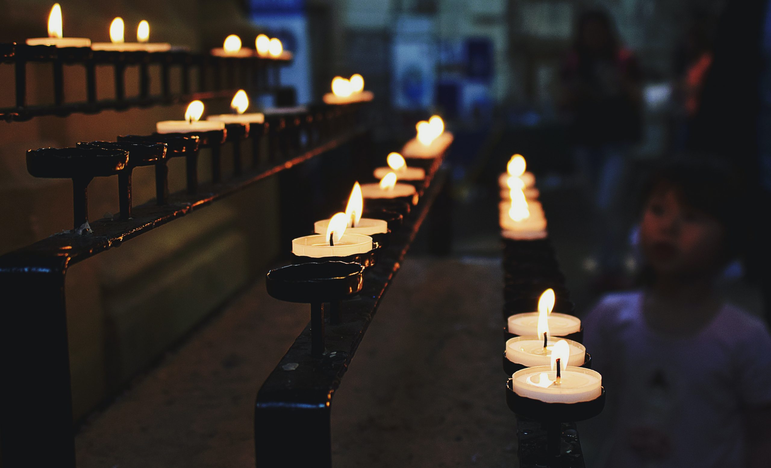 Candles are lit within a church setting